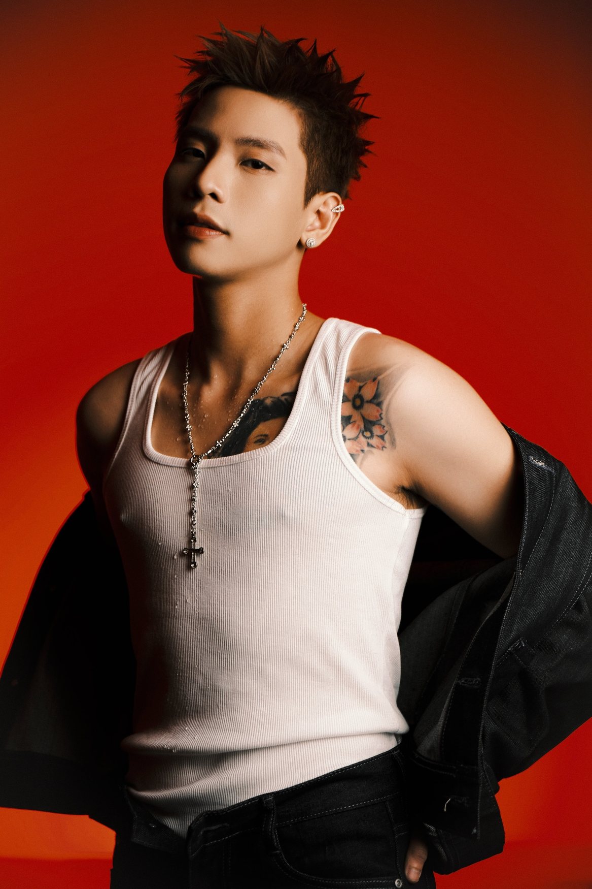 Quân A.P official artist photo on red backdrop